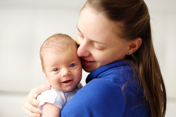One month old newborn baby with mother