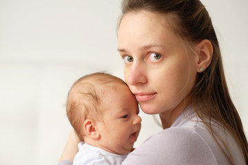 One month old newborn baby with mother