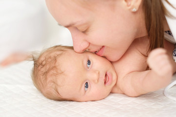 One month old newborn baby with mother