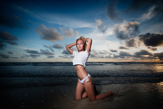 beautiful full body asian woman posing sexy on  sunset beach
