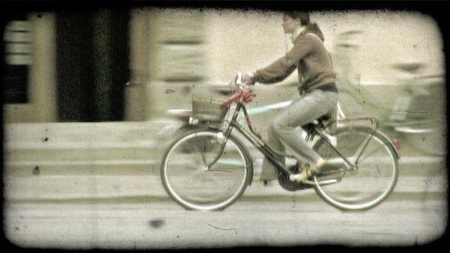 Woman riding bicycle 1. Vintage stylized video clip.