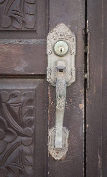Antique door handle and old wooden door
