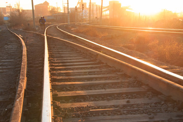 Fototapeta na wymiar Railroad tracks at sunset