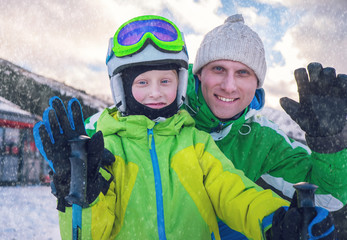 Father with son portrait on ski snow resort