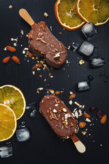 Fototapeta na wymiar Ice cream in chocolate with almond and orange