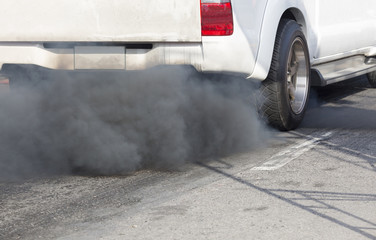 Air pollution from vehicle exhaust pipe on road