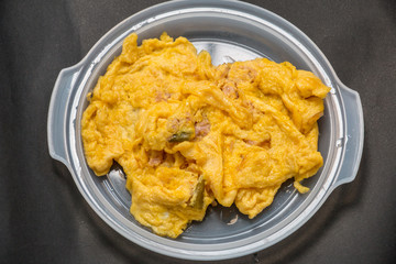 Pork omelet on a plastic plate