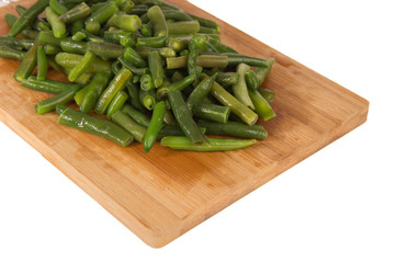 Green string beans on a wooden board