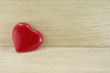 gloss heart on wooden background