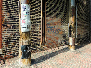 Telephone poles against brick wall in urban area isometric