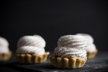 Creamy cake on the dark rustic background. Shallow depth of field.