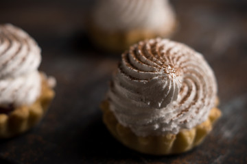 Creamy cake on the dark rustic background. Shallow depth of field.