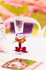 Decorated wedding glass with a red ribbon bow