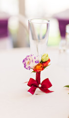 Decorated wedding glass with a red ribbon bow