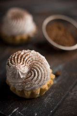 Creamy cake on the dark rustic background. Shallow depth of field.