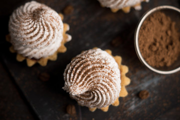 Creamy cake on the dark rustic background. Shallow depth of field.
