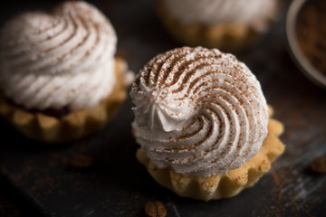 Creamy cake on the dark rustic background. Shallow depth of field.