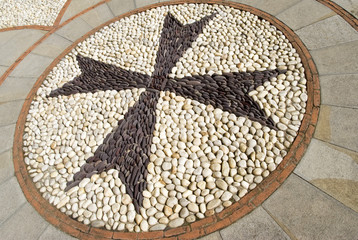 Cobblestone pavement mosaic in the shape of a cross