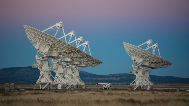 Satellites Rotating Slowly During Sunset. a group of satellites from the Ver Large Array in New Mexico rotating slowly
