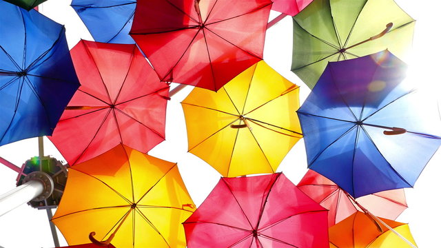 Colourful umbrellas open in the sky as a decoration