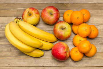 Naklejka na ściany i meble group of apple banana and mandarin fruits on wood