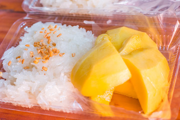 Thai style tropical dessert, glutinous rice eat with mangoes,selected focus