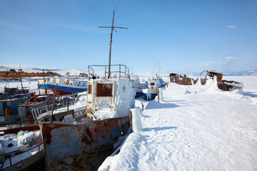 Obraz na płótnie Canvas Old frozen ships in the port of Olkhon island on siberian lake B
