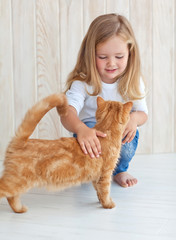 A girl a playing with a cat