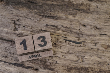 cube calendar on wooden surface for april with copy space