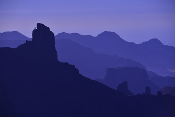 Gran Canaria, Spain.  Telephoto image of the central extinct volcanic landscape with the monolith peak of Bentaiga near the town of Tejeda.