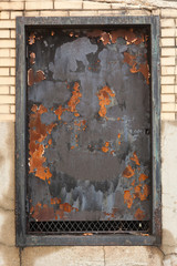 Rusty iron over an old window; vertical image