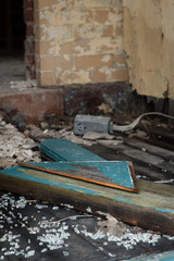 Broken glass and debris inside an abandoned building; vertical image