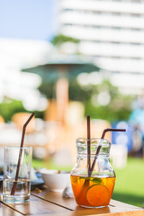 The remaining half a glass of cold lemon tea and mineral water