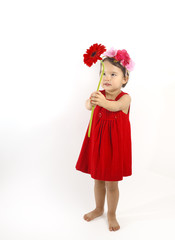 little girl in red dress embracing a red berbera