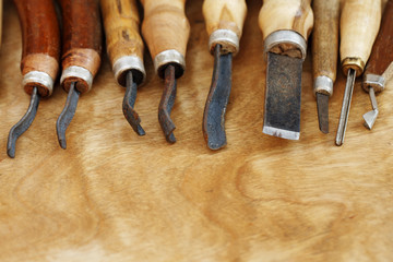 carving tool closeup on wooden background