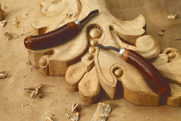 carving tool closeup on wooden background