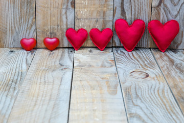 several red hearts on a wooden background for Valentine's Day