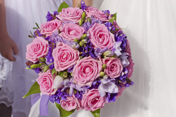 Wedding bouquet in hands of bride