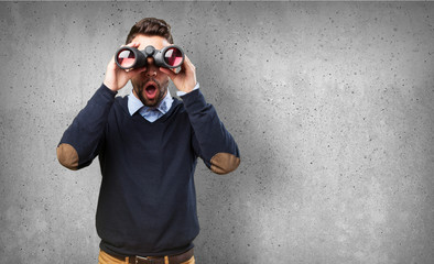 man looking through binoculars