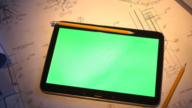 green screen. tablet PC lays on the drawing.