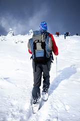 Fototapeta na wymiar Hiker walking at snow mountain