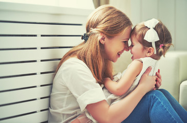 Happy loving family. mother and child playing,  kissing and hugg