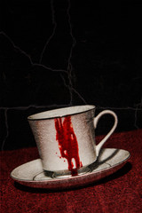 A vampire's tea cup with blood running down the side; textured image - 100145690