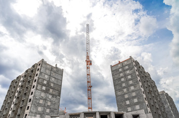 Fototapeta na wymiar New highrise houses and hoist crane