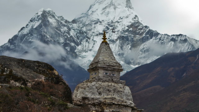 Time-lapse of a buddhist stupa with Ama Dablam peak in the background. Cropped.