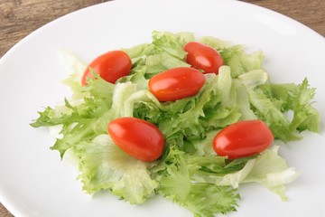 Fresh salad on a wooden background
