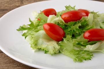 Fresh salad on a wooden background