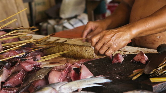 man's hand cut fresh fish