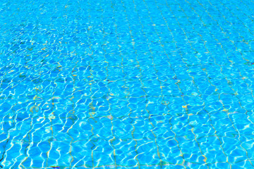 Blue pool water with sun reflections