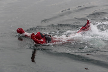 Swimming in an immersion suit